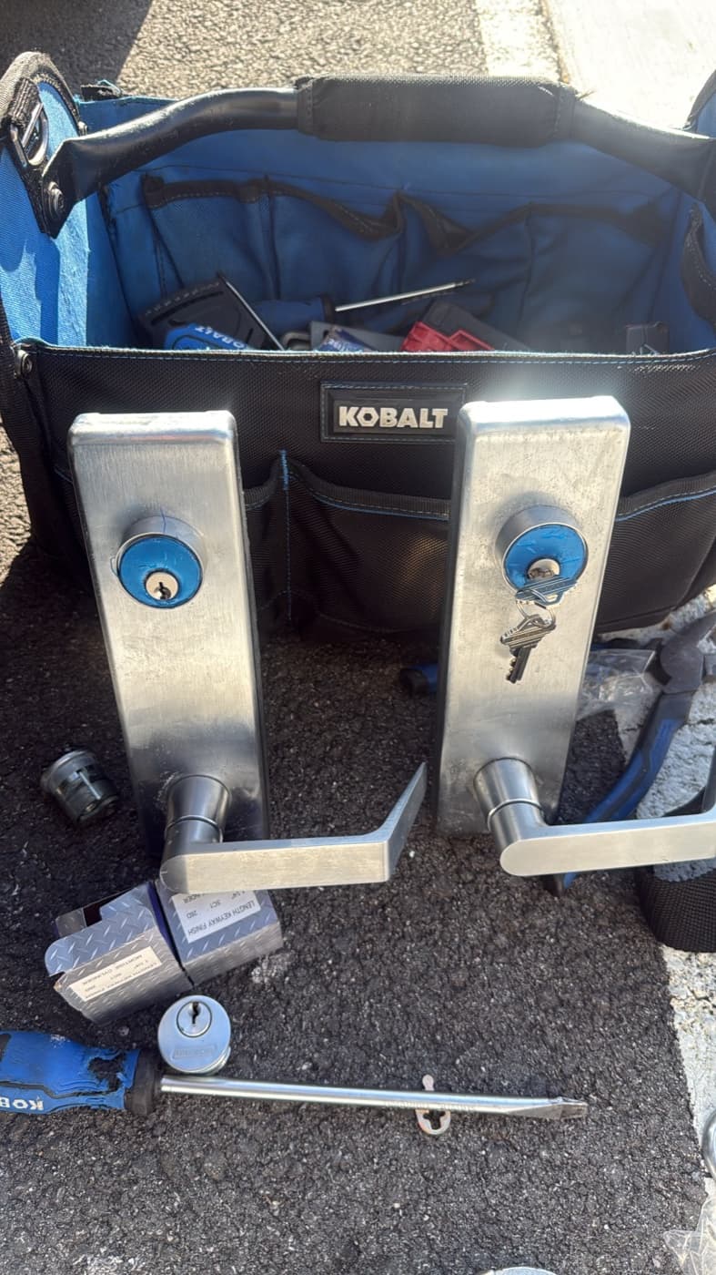 Commercial door hardware being serviced